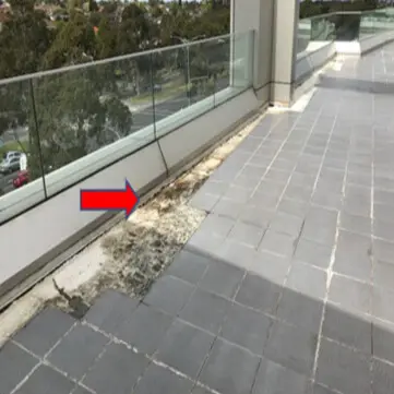 Cracked or loose tiles letting water seep into the floor below